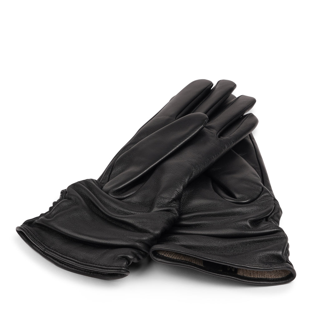 The Asti gloves are crafted from supple leather and lined with luxurious cashmere, offering both elegance and warmth.

Designed with a feminine touch, these gloves provide a sleek and sophisticated look while ensuring superior comfort during colder days. Perfect for adding a touch of refinement to any winter outfit.