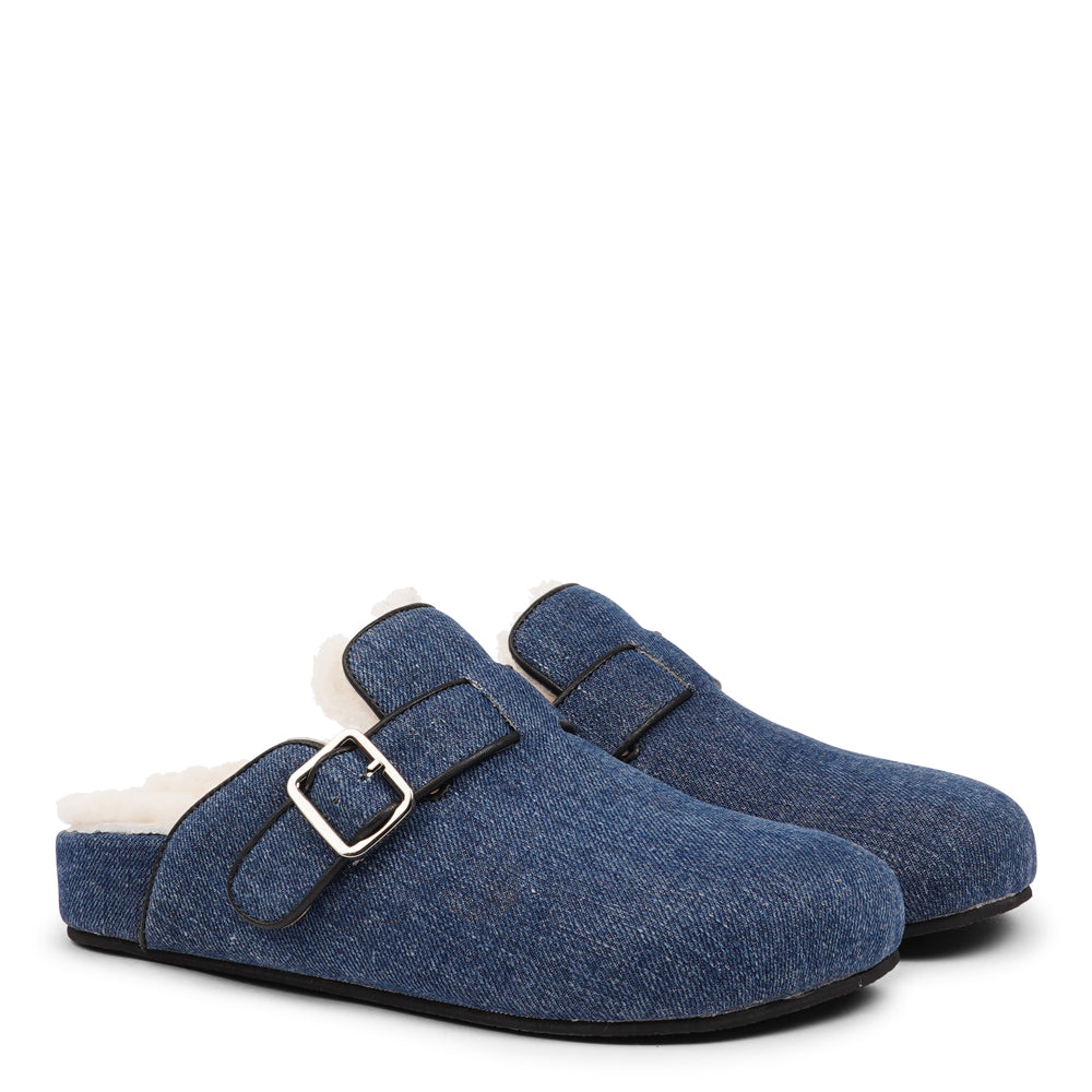 Lovelies Studio - The Nesso Denim Mules are the epitome of luxurious comfort and style. Crafted with a beautiful denim upper, these exclusive mules feature an adjustable buckle for a customized fit. Lined with soft curly shearling, they provide warmth and a cozy feel, perfect for cooler days.&nbsp;

The durable rubber sole ensures long-lasting wear and excellent traction, making them a practical yet indulgent choice. With their elegant design and plush materials, the Nesso Denim Mules effortlessly blend fun