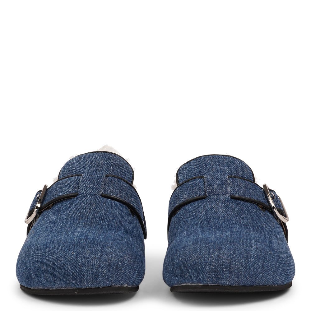 Lovelies Studio - The Nesso Denim Mules are the epitome of luxurious comfort and style. Crafted with a beautiful denim upper, these exclusive mules feature an adjustable buckle for a customized fit. Lined with soft curly shearling, they provide warmth and a cozy feel, perfect for cooler days.&nbsp;

The durable rubber sole ensures long-lasting wear and excellent traction, making them a practical yet indulgent choice. With their elegant design and plush materials, the Nesso Denim Mules effortlessly blend fun