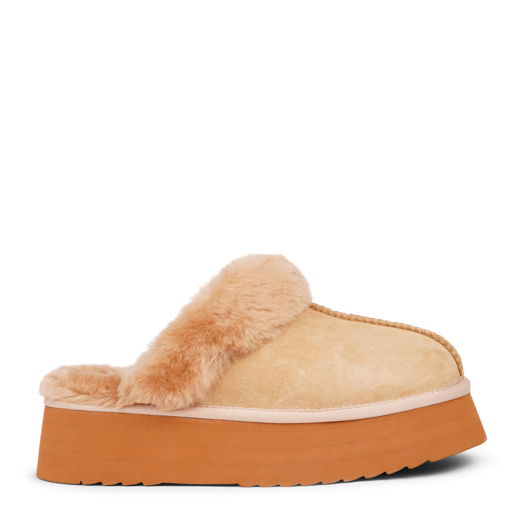 What sets the Robson mules apart is their plush shearling lining, which envelops your feet in a cloud-like cocoon of comfort. The shearling not only adds a touch of opulence but also provides natural insulation, keeping your feet toasty even on the chilliest of days.

But comfort isn't just skin-deep with the&nbsp;Robson mules. The combination of premium suede and the resilient rubber sole ensures durability and longevity, making these mules a dependable choice for daily wear. Whether you're stepping out fo