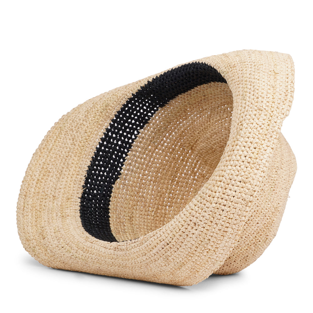 The Summery Viviani hat, a stunning creation meticulously crafted by local artisans in Madagascar exclusively for Lovelies Studio. Each piece is a testament to the skill and dedication of these artisans, who handcraft every detail with precision and care.  Made from raffia, a natural fiber renowned for its durability and flexibility, the Viviani hat is not only stylish but also eco-friendly. The raffia is carefully colored by hand using traditional methods 